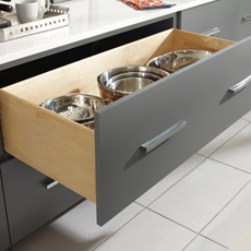 Two drawer base cabinet with top drawer open to show pots and pans storage