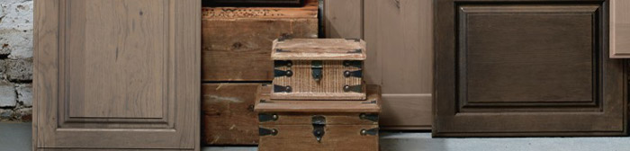 Cabinet doors in various gray finishes arranged with props