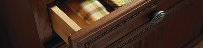 Close-up of open cabinet drawer with linens inside