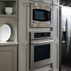 Oven and microwave tall cabinet in a painted gray kitchen