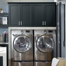 Wall cabinets above a washer and dryer in a laundry room