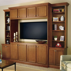 Entertainment center comprised of base, wall and tall cabinets