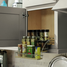 Wall cabinet with pull down spice rack in use