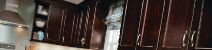 Wall cabinets in a dark brown wood stain