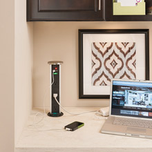 Laptop plugged into a Sensio PowerPod in a home office