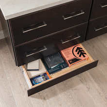 Toekick drawer in home office opened to show storage inside