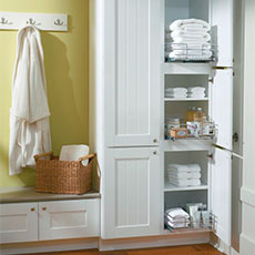 Tall bathroom cabinet opened to show storage capabilities