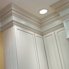 Use cabinetry finishing touches like decorative mouldings, embellishments, and hardware to enhance your laundry room design.