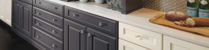 Two-tone painted base cabinets with glass door knobs