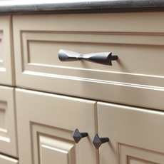 Close up of cabinet with matching pull and knobs