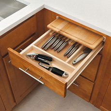 Cabinet drawer open to show cutlery tray and cutting board kit