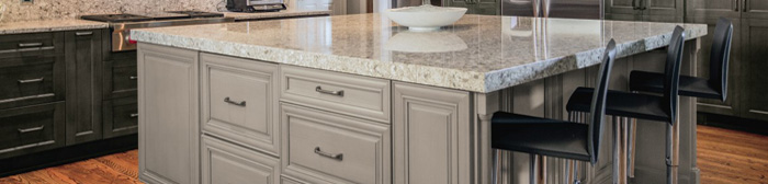 Close up of light gray kitchen island with seating
