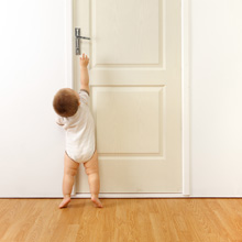 Child trying to open a closed door