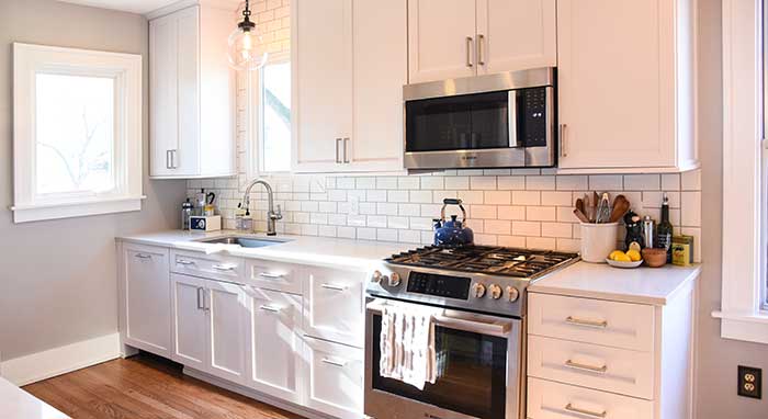 Small kitchen renovated with white cabinets by Omega