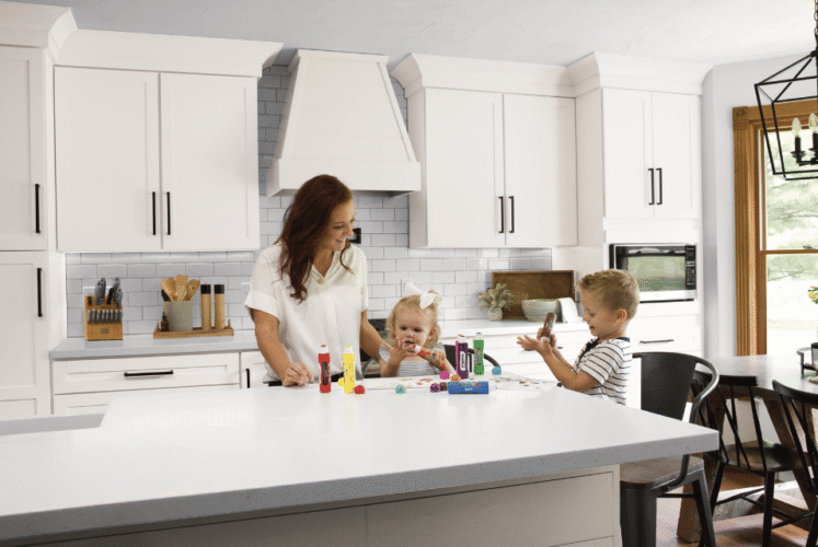 Family-friendly kitchen with white shaker cabinets and large island seating