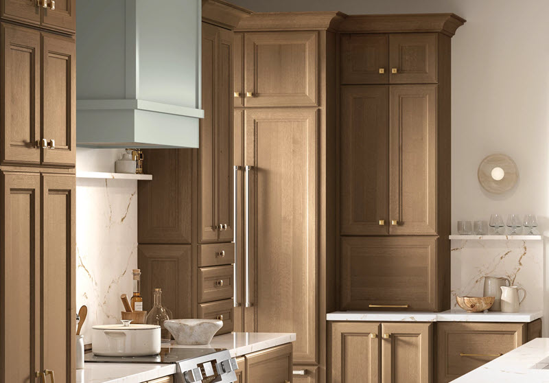 Choosing Cabinet Hardware: Decora Cabinetry door styles Kanon and Sabine in full overlay configuration on framed cabinet construction. Cabinets shown in Maple with Crepe finish