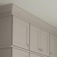 Cabinet moulding and hardware on light gray kitchen cabinets
