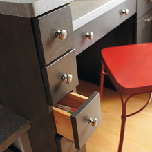 Close up of office area in kitchen with spice drawers for storage